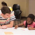 photo of volunteer working with after school girl