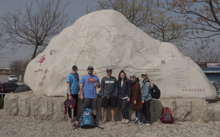students standing in front of monument