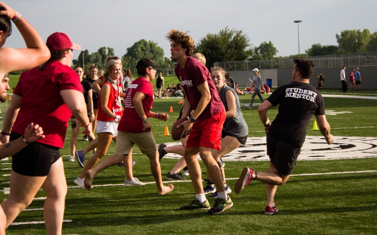 Students and mentors run during games at Siren