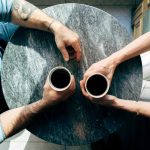 Man and woman conversing over coffee at a table