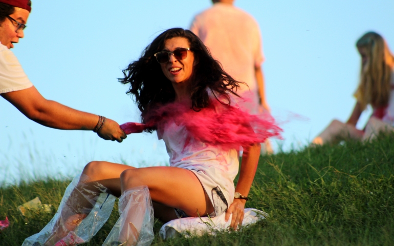 A female student being helped to slide down the hill on a block of ice