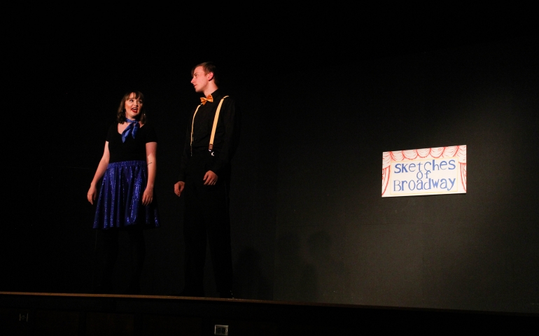A man and woman on stage singing