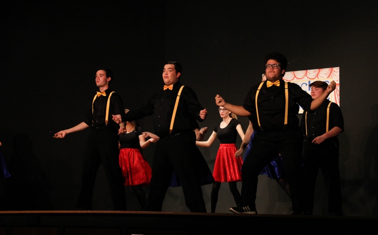 Three men dancing and singing