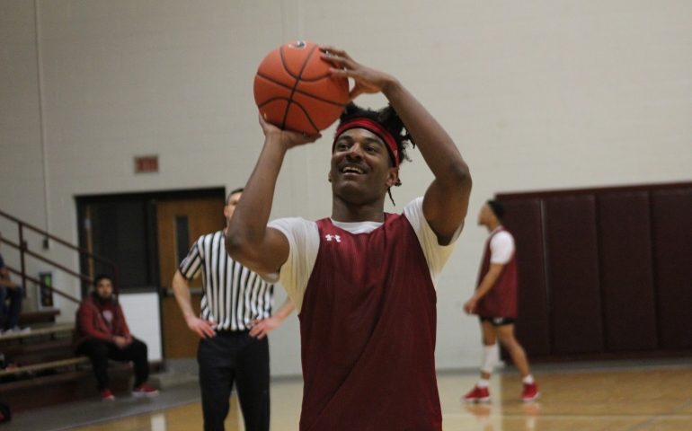A student shooting a jump shot