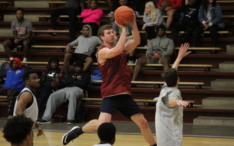 A student goes up for a wonky jump shot