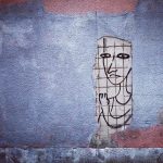 Sketch of person imprisoned on a wall