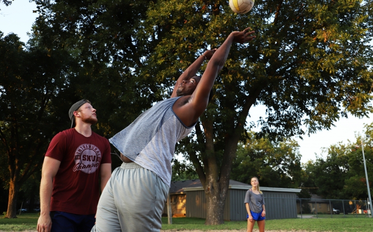 Guy leaning backward to set the ball