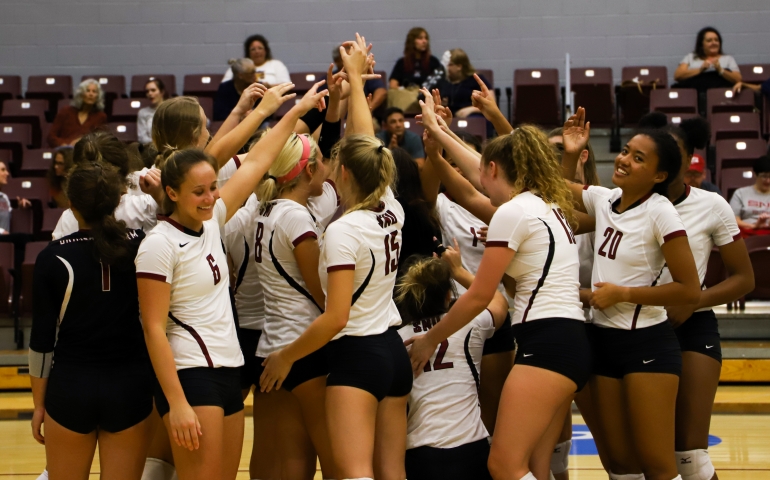Volleyball team huddled together