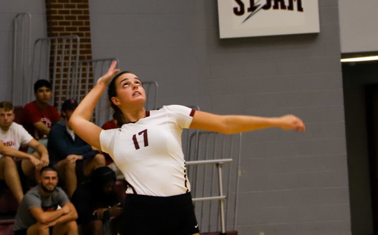 Volleyball player jumping to serve