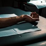 Person laying their arm down to get a tattoo