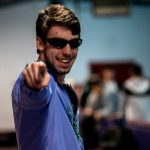 One student pointing at the camera while skating