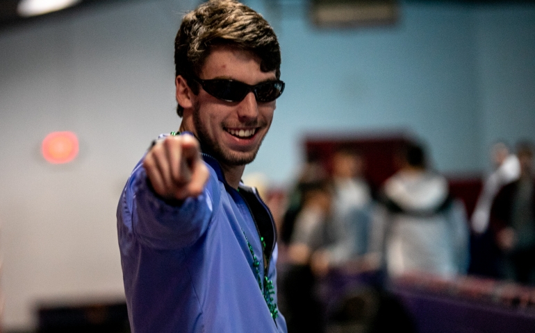 One student pointing at the camera while skating